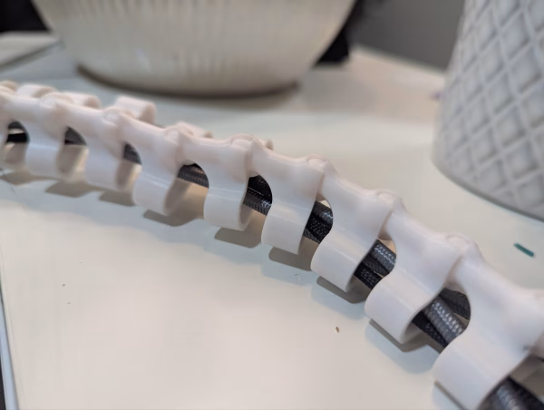 3D printed cable spine organizer mounted in Cooler Master NR200 case